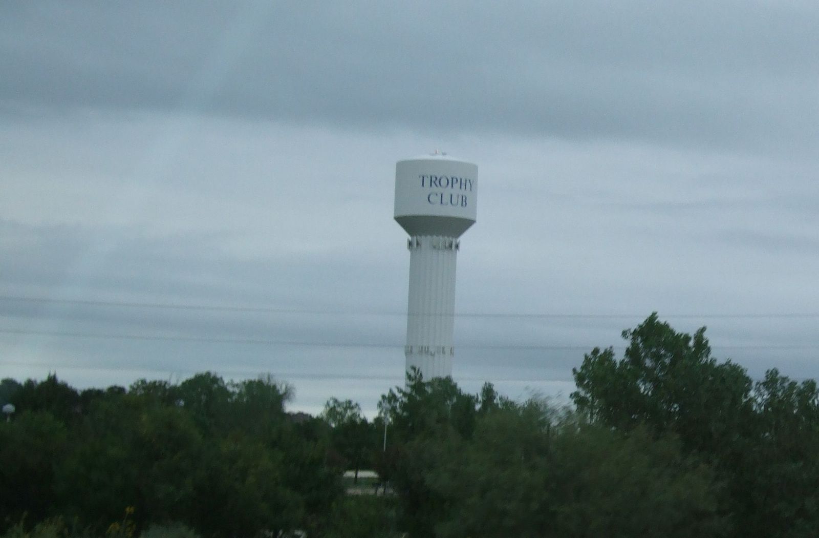 Trophy Club, Texas water tower above the treeline